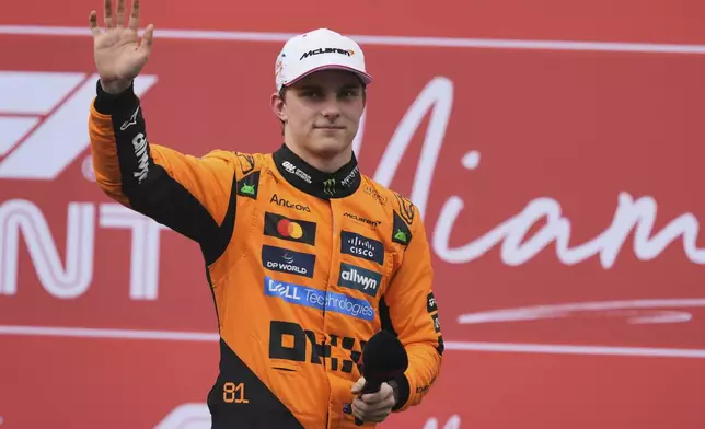 Second place finisher McLaren driver Oscar Piastri of Australia greets fan during a trophy ceremony after the Sprint race at the Formula One Miami Grand Prix auto race, Saturday, May 3, 2025, in Miami Gardens, Fla. (AP Photo/Rebecca Blackwell)
