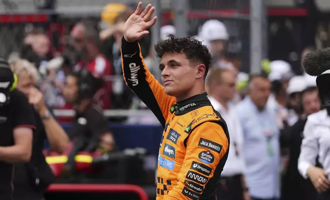 First place finisher McLaren driver Lando Norris of Britain greets the crowd during a trophy ceremony after the Sprint race at the Formula One Miami Grand Prix auto race, Saturday, May 3, 2025, in Miami Gardens, Fla. (AP Photo/Rebecca Blackwell)