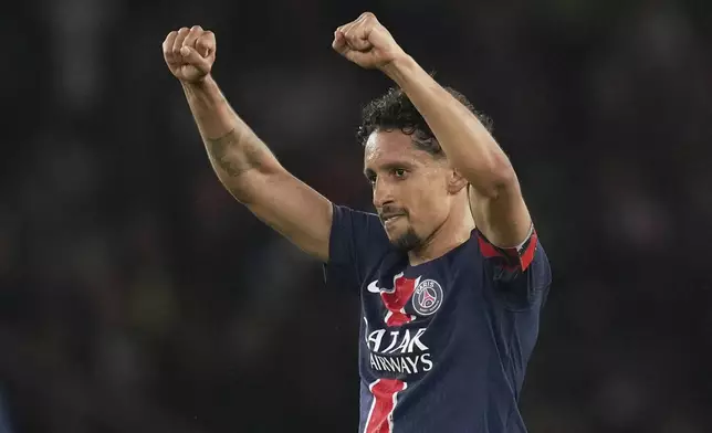 PSG's Marquinhos celebrates after scoring his side's second goal during the French League One soccer match between Paris Saint-Germain and Auxerre at the Parc des Princes stadium in Paris, Saturday, May 17, 2025. (AP Photo/Christophe Ena)