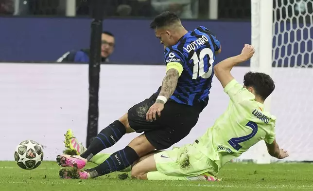 Barcelona's Pau Cubarsi fouls Inter Milan's Lautaro Martinez inside the penalty box during the Champions League semifinal second leg soccer match between Inter Milan and Barcelona at San Siro stadium in Milan , Italy, Tuesday, May 6, 2025. (AP Photo/Antonio Calanni)