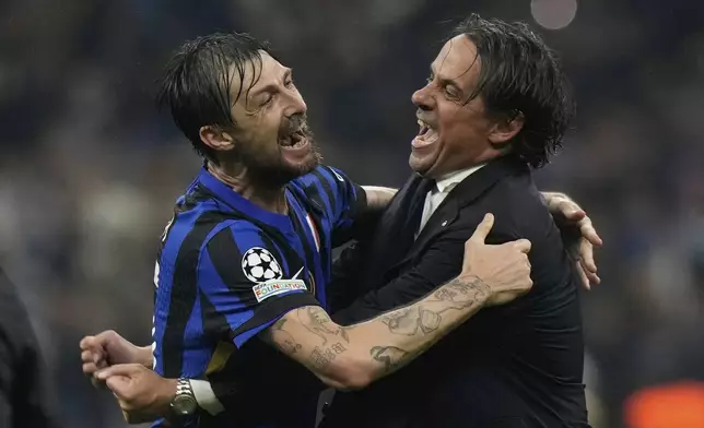 Inter Milan's head coach Simone Inzaghi, right, celebrates with Inter Milan's Francesco Acerbi at the end of the Champions League semifinal second leg soccer match between Inter Milan and Barcelona at San Siro stadium in Milan , Italy, Tuesday, May 6, 2025. (AP Photo/Luca Bruno)