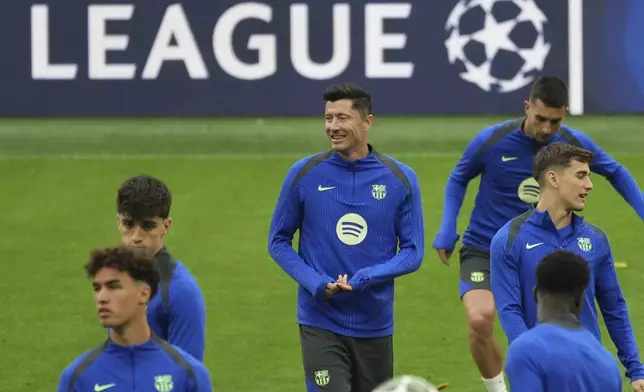 Barcelona's Robert Lewandowski, centre, smiles during a training at the San Siro stadium in Milan, Italy, Monday, May 5, 2025, ahead of the Champions League semifinals second leg soccer match between Inter Milan and Barcelona on Tuesday. (AP Photo/Antonio Calanni)