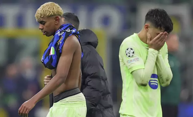 Barcelona's Lamine Yamal, left, reacts after the Champions League semifinal second leg soccer match between Inter Milan and Barcelona at San Siro stadium in Milan , Italy, Tuesday, May 6, 2025. (Spada/LaPresse via AP)