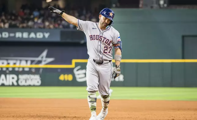 Houston Astros' Jose Altuve celebrates a hit during the fifth inning of a baseball game against the Texas Rangers, Saturday, May 17, 2025, in Arlington, Texas. (AP Photo/Jessica Tobias)