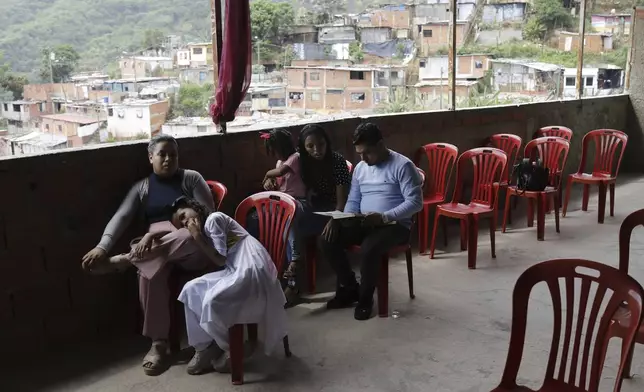 Congregants attend a service at the Resurrection evangelical church led by Pastor Fernanda Egle, in Caracas, Venezuela, Sunday, May 18, 2025. (AP Photo/Cristian Hernandez)