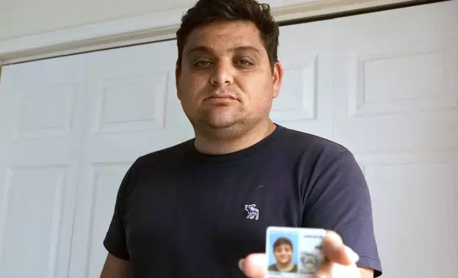 Spencer Goidel, an Equal Employment Opportunity Specialist with the Internal Revenue Service who was notified his job would be eliminated as part of the government's efficiency cuts, shows his government ID in Boca Raton, Fla., April 16, 2025. (AP Photo/Daniel Kozin)