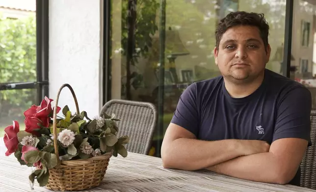 Spencer Goidel, an Equal Employment Opportunity Specialist with the Internal Revenue Service who was notified his job would be eliminated as part of the government's efficiency cuts, poses for a portrait at his home in Boca Raton, Fla., April 16, 2025. (AP Photo/Daniel Kozin)