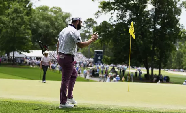 Jon Rahm, of Spain, waves after making a putt on the third hole during the third round of the PGA Championship golf tournament at the Quail Hollow Club, Saturday, May 17, 2025, in Charlotte, N.C. (AP Photo/George Walker IV)