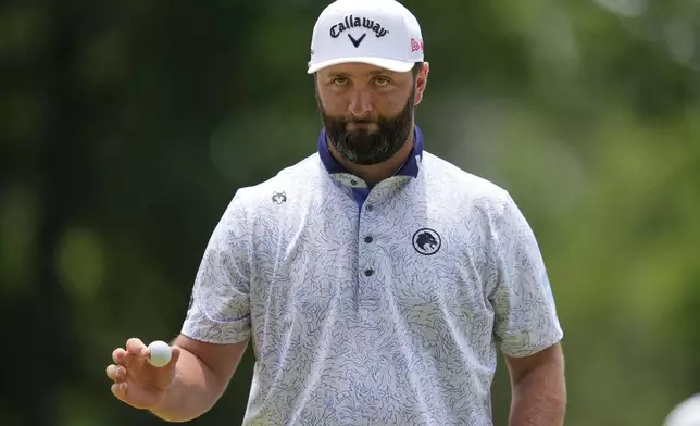 Jon Rahm, of Spain, waves after making a putt on the first hole during the third round of the PGA Championship golf tournament at the Quail Hollow Club, Saturday, May 17, 2025, in Charlotte, N.C. (AP Photo/George Walker IV)