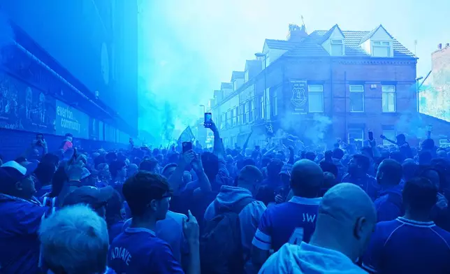 Everton fans let off flares before the English Premier League soccer match between Everton and Southampton, the last to be played at Goodison Park, Liverpool, England, Sunday, May 18, 2025. (Martin Rickett/PA via AP)