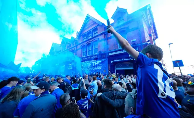 Everton fans let off flares before the English Premier League soccer match between Everton and Southampton, the last to be played at Goodison Park, Liverpool, England, Sunday, May 18, 2025. (Martin Rickett/PA via AP)