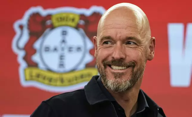 Erik ten Hag smiles during his presentation as new head coach of Bundesliga soccer club Bayer 04 Leverkusen at the BayArena stadium in Leverkusen, Germany, Monday, May 26, 2025. (AP Photo/Martin Meissner)