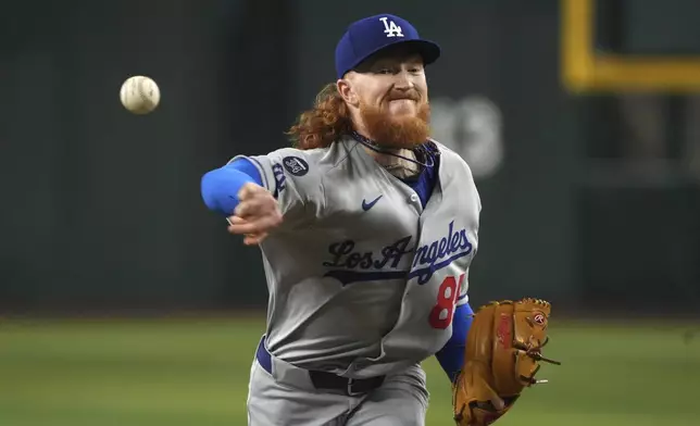 Los Angeles Dodgers pitcher Dustin May throws against the Arizona Diamondbacks in the first inning during a baseball game, Saturday, May 10, 2025, in Phoenix. (AP Photo/Rick Scuteri)
