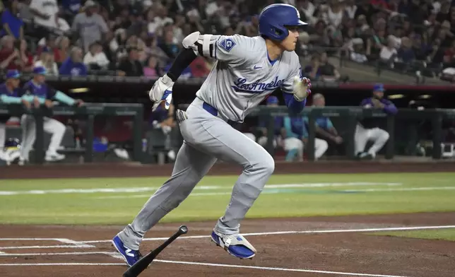 Los Angeles Dodgers' Shohei Ohtani starts to run after hitting a single against the Arizona Diamondbacks in the first inning during a baseball game, Saturday, May 10, 2025, in Phoenix. (AP Photo/Rick Scuteri)