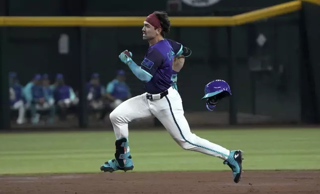 Arizona Diamondbacks' Corbin Carroll runs after hitting a triple against the Los Angeles Dodgers in the third inning during a baseball game, Saturday, May 10, 2025, in Phoenix. (AP Photo/Rick Scuteri)