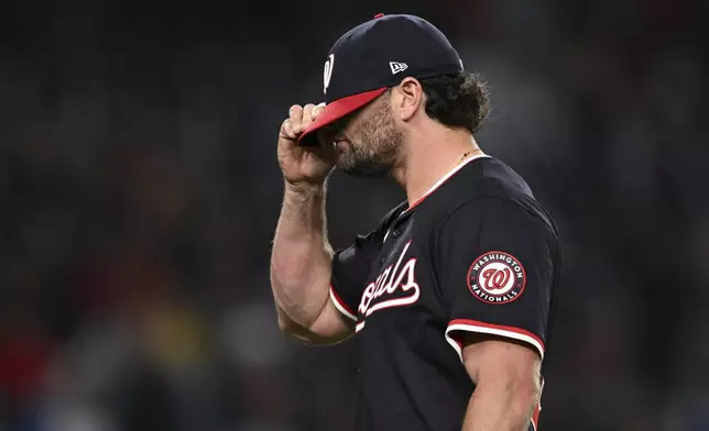 Washington Nationals pitcher Kyle Finnegan reacts as he walks off the mound during the ninth inning of a baseball game against the Atlanta Braves in Washington, Thursday, May 22, 2025. (AP Photo/Terrance Williams)