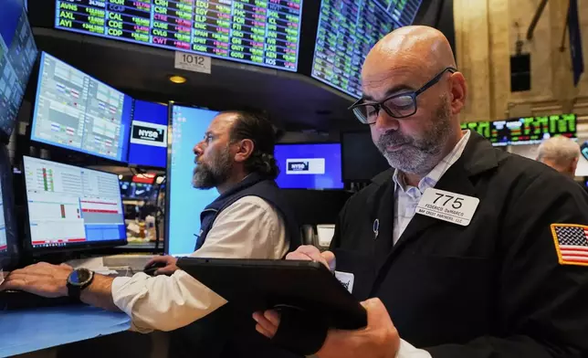 Specialist Michael Pistillo, left, and trader Fred Demarco work on the floor of the New York Stock Exchange, Friday, May 2, 2025. (AP Photo/Richard Drew)
