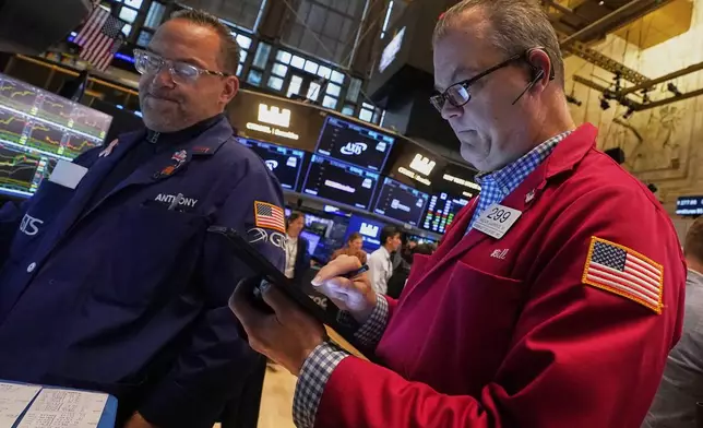 Specialist Anthony Matesic, left, and trader William Lawrence work on the floor of the New York Stock Exchange, Friday, May 2, 2025. (AP Photo/Richard Drew)