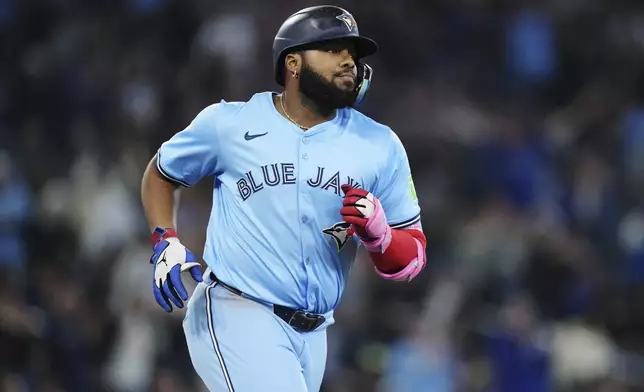 Toronto Blue Jays' Vladimir Guerrero Jr. (27) rounds the bases after his two-run home run against the Athletics during the second inning of a baseball game in Toronto, Thursday, May 29, 2025. (Nathan Denette/The Canadian Press via AP)