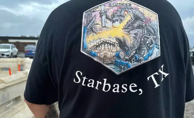 A man with Proposed new name for the town on his T-shirt is seen in Boca Chica, Texas, that would become Starbase, Texas, if local residents approve a measure to make the area surrounding the rocket launch site its own city. (AP Photo/Valerie Gonzalez)