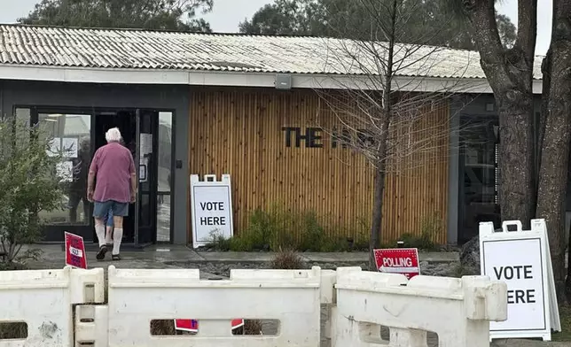 People enter a polling station in the town of of Boca Chica, Texas, that would become Starbase, Texas, if local residents approve a measure to make the home of Elon Musk's SpaceX its own city on Saturday, May 3, 2025. (AP Photo/Valerie Gonzalez)