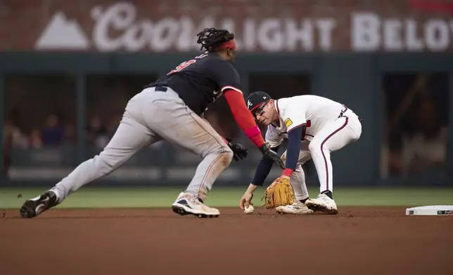 Atlanta Braves' Nick Allen (2) reaches to tag Washington Nationals' Josh Bell (19) in the fourth inning of a baseball game, Wednesday, May 14, 2025 in Atlanta. (AP Photo/Kathryn Skeean)