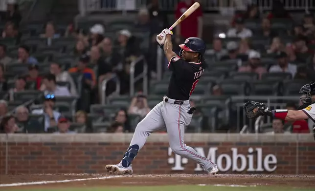Washington Nationals' José Tena (8) gets a base hit in the seventh inning of a baseball game against the Atlanta Braves Wednesday, May 14, 2025 in Atlanta. (AP Photo/Kathryn Skeean)