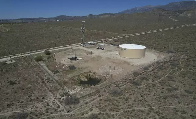 A newly installed Heli-Hydrant, a small, open tank that helicopters can rely on to get water faster for urban fires, sits in Cabazon, Calif., Friday, April 11, 2025. (AP Photo/Brittany Peterson)