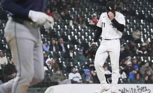 Chicago White Sox relief pitcher Cam Booser looks down as Seattle Mariners' J.P. Crawford walks to first base during the eighth inning of a baseball game in Chicago, Monday, May 19, 2025. (AP Photo/Nam Y. Huh)