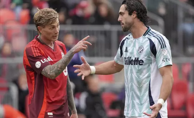 Toronto FC forward Federico Bernardeschi (10) and New England Revolution forward Leonardo Campana (9) argue during the first half of an MLS soccer game in Toronto, Saturday, May 3, 2025. (Frank Gunn/The Canadian Press via AP)