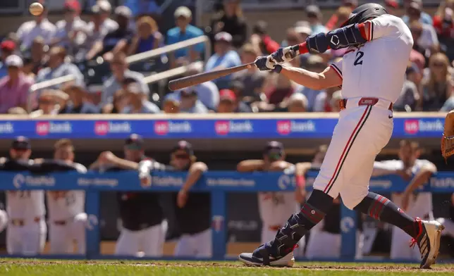 Minnesota Twins' Brooks Lee hits a two-run double against the Baltimore Orioles in the eighth inning of a baseball game Thursday, May 8, 2025, in Minneapolis. (AP Photo/Bruce Kluckhohn)