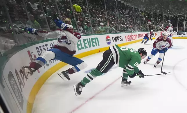 Colorado Avalanche defenseman Erik Johnson, left, and Dallas Stars right wing Mikko Rantanen (96) collide while competing for the puck during the first period in Game 2 of a first-round NHL hockey playoff series Monday, April 21, 2025, in Dallas. (AP Photo/Julio Cortez)