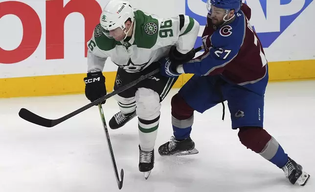 Dallas Stars right wing Mikko Rantanen, left, gets tied up by Colorado Avalanche left wing Jonathan Drouin in overtime of Game 3 of an NHL hockey first-round playoff series Wednesday, April 23, 2025, in Denver. (AP Photo/David Zalubowski)