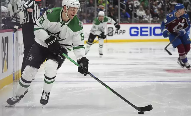 Dallas Stars right wing Mikko Rantanen brings the puck down the ice in the second period of Game 3 of an NHL hockey first-round playoff series against the Colorado Avalanche Wednesday, April 23, 2025, in Denver. (AP Photo/David Zalubowski)