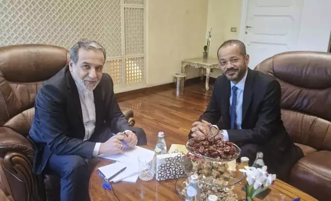 In this photo released by the Iranian Foreign Ministry, Iranian Foreign Minister Abbas Araghchi, left, meets with his Omani counterpart Sayyid Badr Albusaidi at the Omani Embassy in Rome during the fifth round of Iran-U.S. negotiations, Friday, May 23, 2025. (Iranian Foreign Ministry via AP)