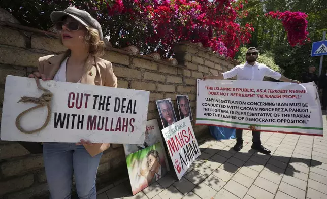 Iranian citizens protest against the current Iranian government outside the Omani Embassy in Rome during the closed-door meeting between U.S. and Iranian delegations to discuss Tehran's rapidly advancing nuclear program, Friday, May 23, 2025. (AP Photo/Andrew Medichini)