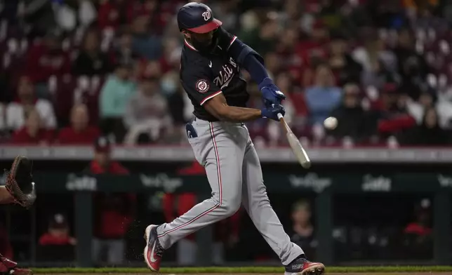 Washington Nationals' Amed Rosario hits a three-run home run in the sixth inning of a baseball game against the Cincinnati Reds, Saturday, May 3, 2025, in Cincinnati. (AP Photo/Carolyn Kaster)
