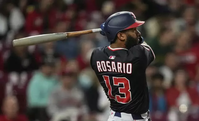 Washington Nationals' Amed Rosario watches his three-run home run in the sixth inning of a baseball game against the Cincinnati Reds, Saturday, May 3, 2025, in Cincinnati. (AP Photo/Carolyn Kaster)
