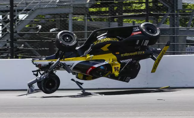 The car driven by Colton Herta goes airborne after hitting the wall in the first turn during a qualification attempt for the Indianapolis 500 auto race at Indianapolis Motor Speedway in Indianapolis, Saturday, May 17, 2025. (AP Photo/Kirk DeBrunner)