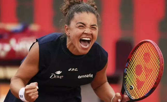 Jasmine Paolini, of Italy, reacts to defeating Coco Gauff, of the United States, at the end of their Italian Open tennis match final, at the Foro Italico in Rome, Saturday, May 17, 2025. (AP Photo/Alessandra Tarantino)