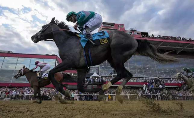 Umberto Rispoli, left, atop Journalism, edges out Luis Saez, atop Gosger, to win the 150th running of the Preakness Stakes horse race Saturday, May 17, 2025, at Pimlico Race Course in Baltimore. (AP Photo/Stephanie Scarbrough)