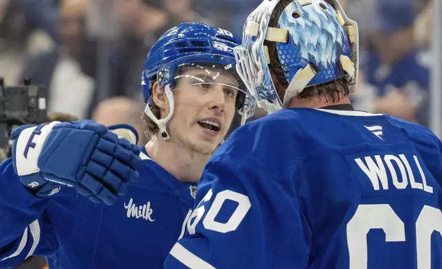 Toronto Maple Leafs' Mitch Marner (16) celebrates with goaltender Joseph Woll (60) after defeating the Florida Panthers in NHL playoff hockey action in Toronto on Wednesday, May 7, 2025. (Frank Gunn/The Canadian Press via AP)