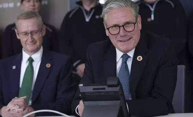 Britain's Prime Minister Keir Starmer speaks on the phone to US President Donald Trump at a car factory in the West Midlands, Thursday, May 8, 2025.(AP Photo/Alberto Pezzali, Pool)