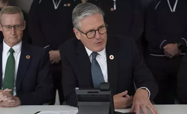 Britain's Prime Minister Keir Starmer speaks on the phone to US President Donald Trump at a car factory in the West Midlands, Thursday, May 8, 2025.(AP Photo/Alberto Pezzali, Pool)