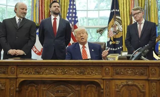 President Donald Trump, center, with from l-r., Commerce Secretary Howard Lutnick, Vice President JD Vance, and Britian's ambassador to the United States Peter Mandelson, making remarks on a trade deal between U.S. and U.K. in the Oval Office of the White House, Thursday, May 8, 2025, in Washington. (AP Photo/Evan Vucci)