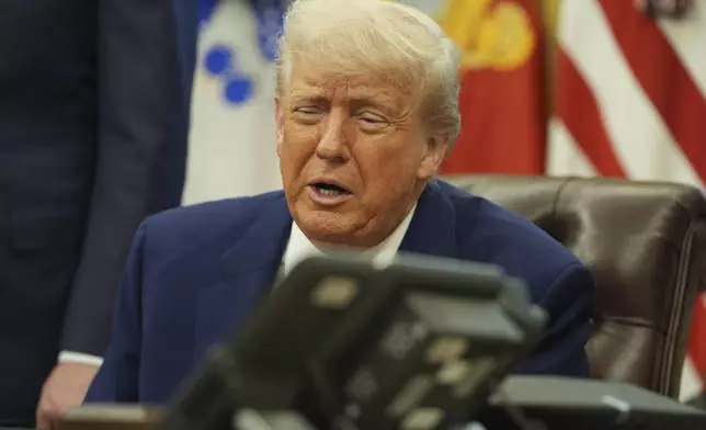 President Donald Trump speaks on the phone to Britian's Prime Minister Keir Starmer aon a trade deal between the US and United Kingdom in the Oval Office of the White House, Thursday, May 8, 2025, in Washington. (AP Photo/Evan Vucci)