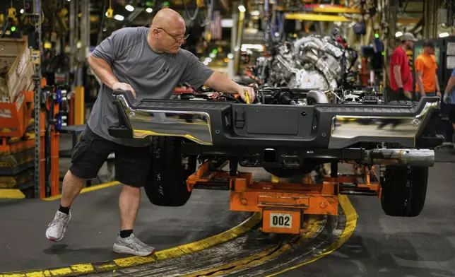 Vehicle assembly technician Kevin Zepernick works on a 2025 Ford Expedition during a media tour to launch the 2025 Ford Expedition at the Ford Motor Company Kentucky Truck Plant, Wednesday, April 30, 2025, in Louisville, Ky. (AP Photo/Carolyn Kaster)