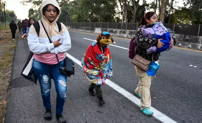 FILE - Women and children migrants walk with a larger group of migrants through Tapachula, Chiapas state, Mexico, in an attempt to reach the U.S. border, Jan. 20, 2025, the inauguration day of U.S. President Donald Trump. (AP Photo/Edgar H. Clemente, FIle)