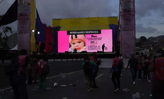 A screen shows an image of Maikelys Espinoza, a 2-year-old in US custody whose parents were deported separately, after a pro-government May Day rally in Caracas, Venezuela, Thursday, May 1, 2025. (AP Photo/Ariana Cubillos)