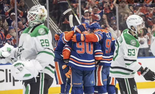 Edmonton Oilers players celebrate a goal as Dallas Stars goalie Jake Oettinger (29) and Wyatt Johnston (53) look on during second period NHL Western Conference final playoff action, in Edmonton on Tuesday, May 27, 2025. (Jason Franson/The Canadian Press via AP)